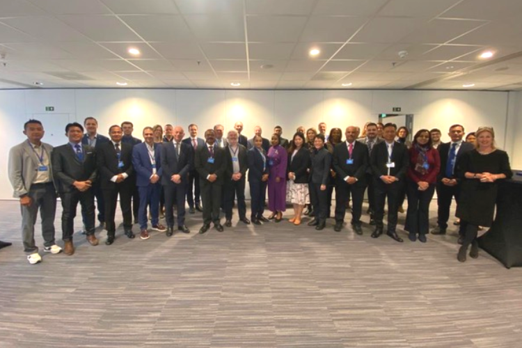A large group of people stand in a row