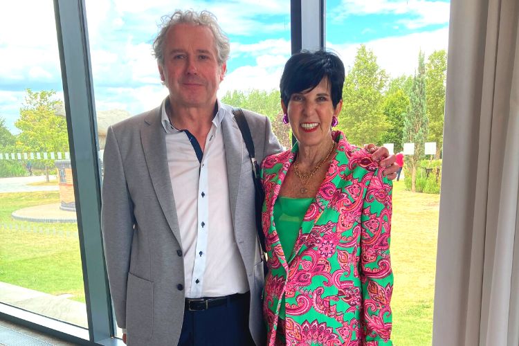 Professor Paul Crawford is on the left, wearing a grey blazer and white shirt. On the right is Jill Berelowitz wearing a pink patterned trouser suit (only visible above the waist)