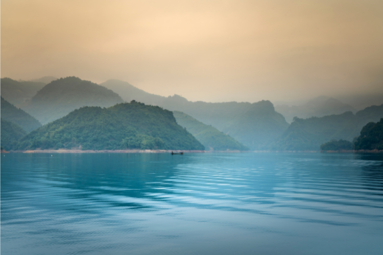 Misty mountains above a lake